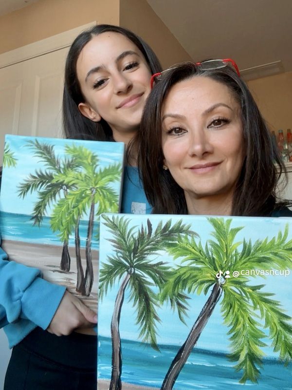 A painting of cactus and flowers with a sunset in the background.