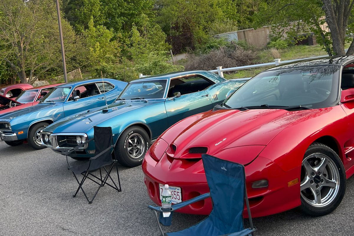 A red car is parked next to a blue car
