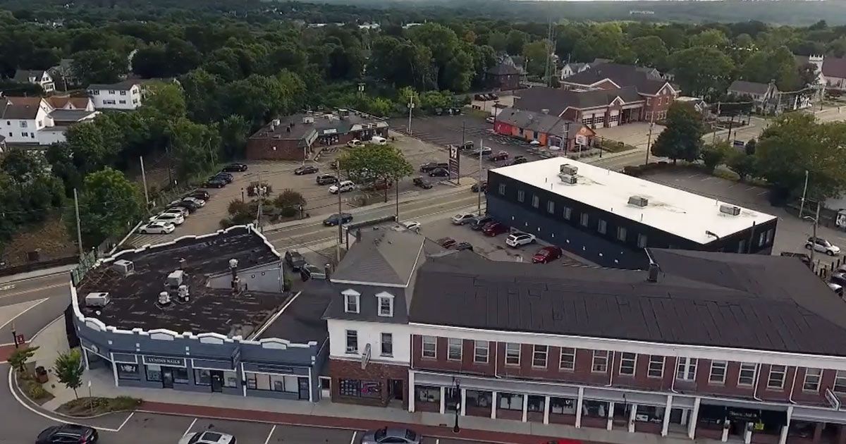 An aerial view of a city with a large building in the middle
