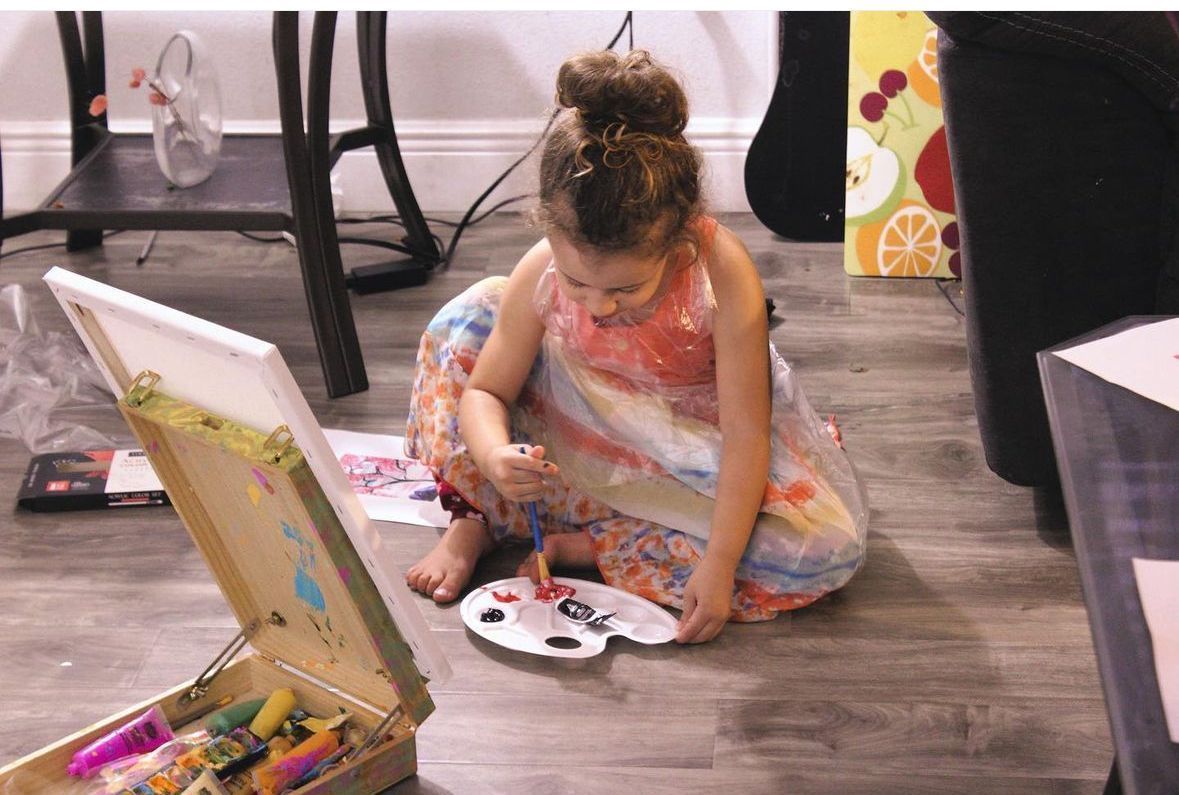 girl painting on the floor