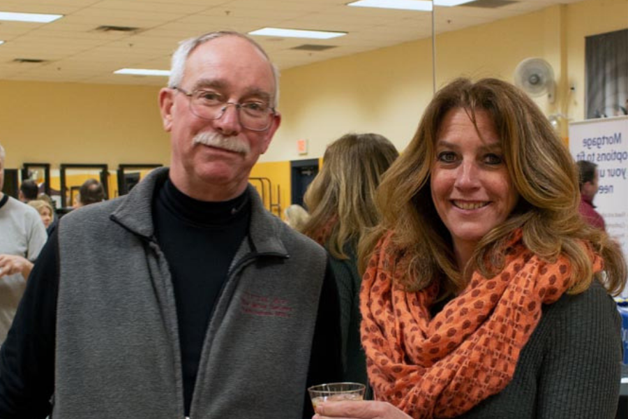 A man and a woman are standing next to each other in a room.