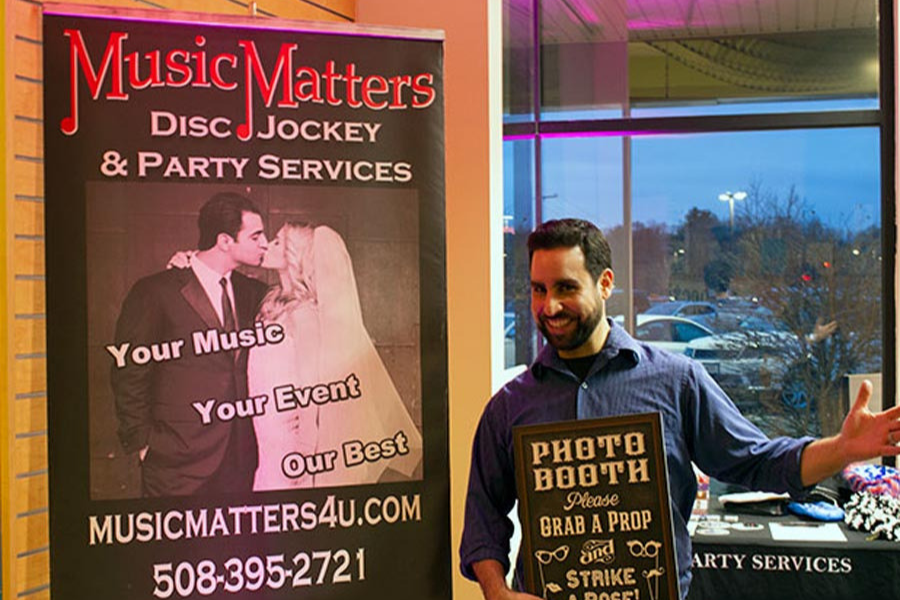 A man holding a sign that says photo booth