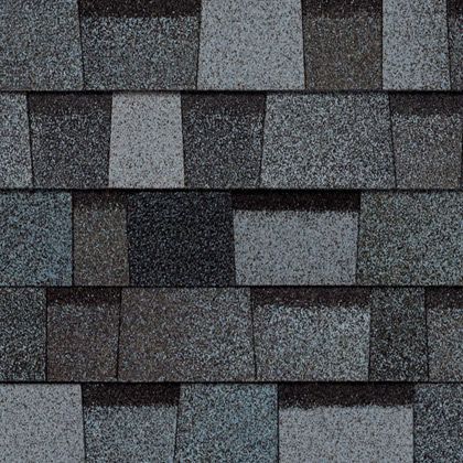 A close up of a roof with gray and black shingles.