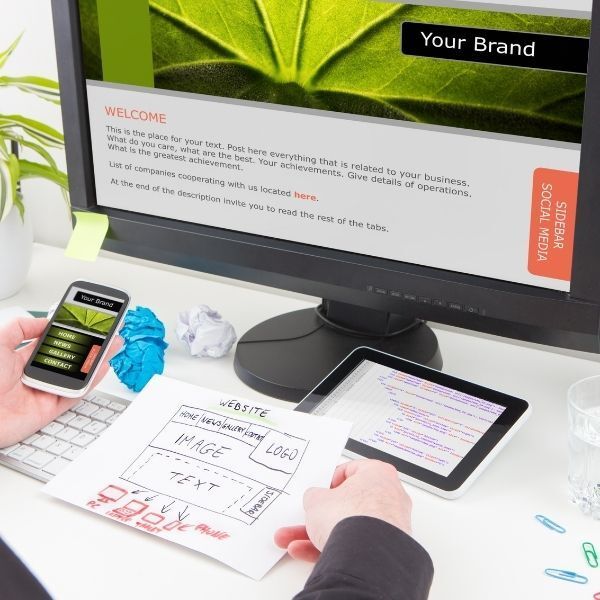 A person is working on a computer with a screen that says your brand