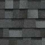 A close up of a row of gray shingles on a roof.