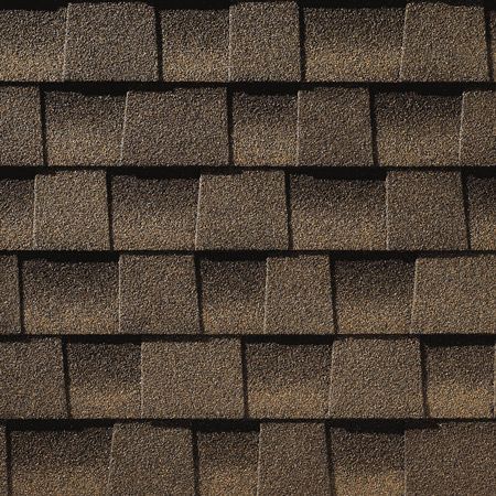 A close up of a roof with brown shingles.