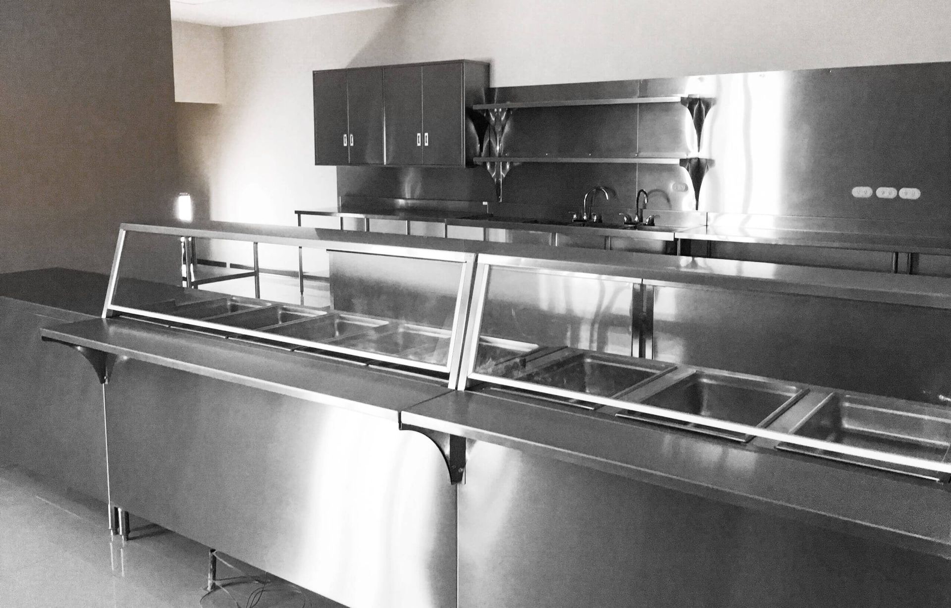 Una fotografía en blanco y negro de una cocina de acero inoxidable.