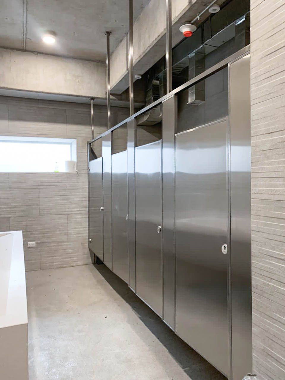 Un baño con puestos de acero inoxidable y lavabo