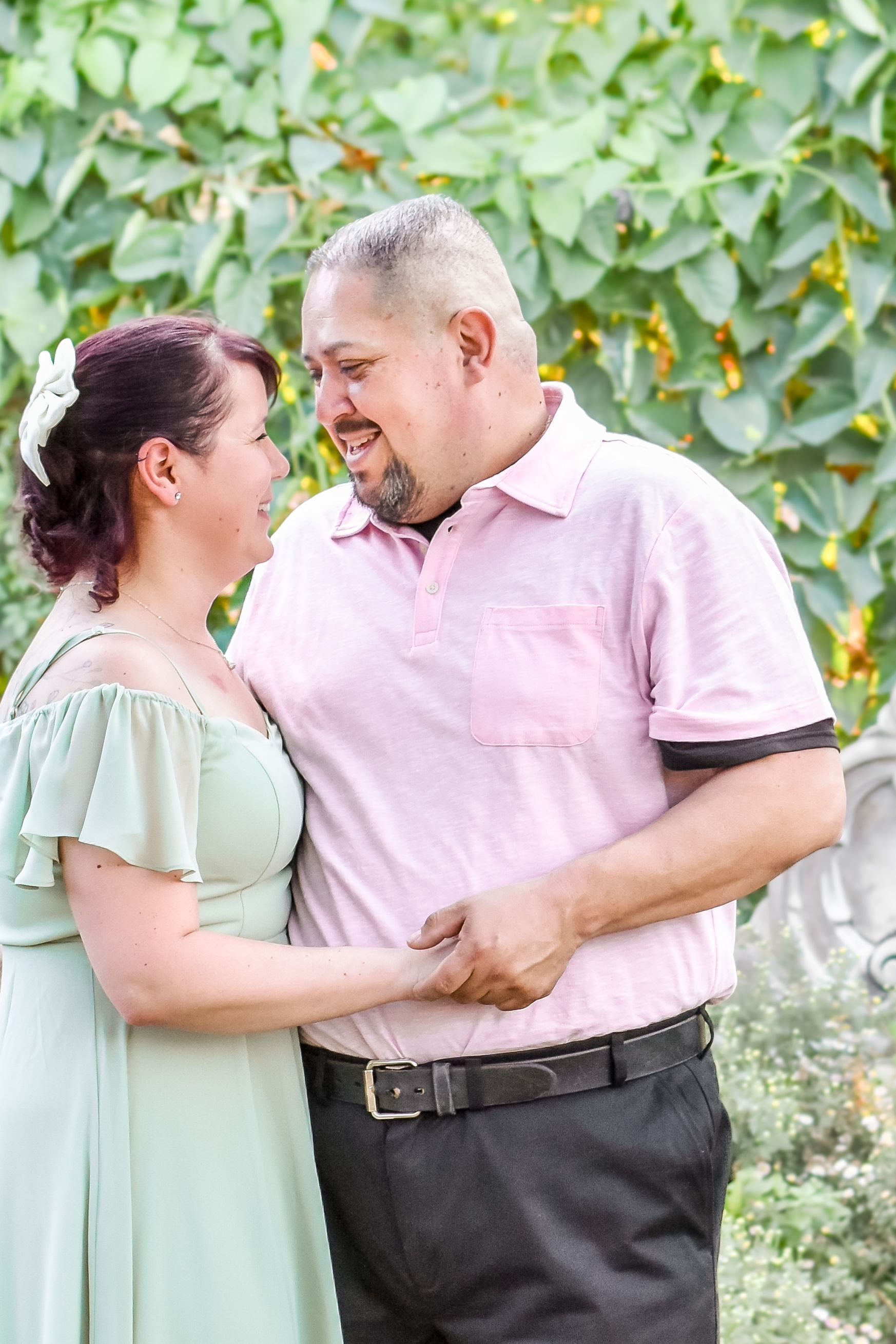 A man and a woman are holding hands and looking at each other in Covina, CA