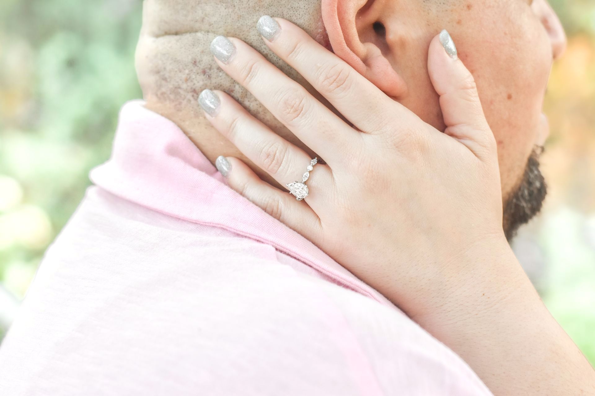 A close up of a woman 's hand with an engagement ring on her finger in Covina.