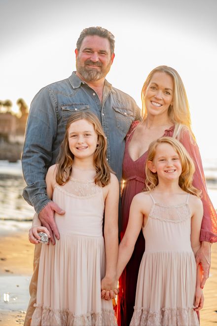 A family is posing for a picture with a dog at Averill Park