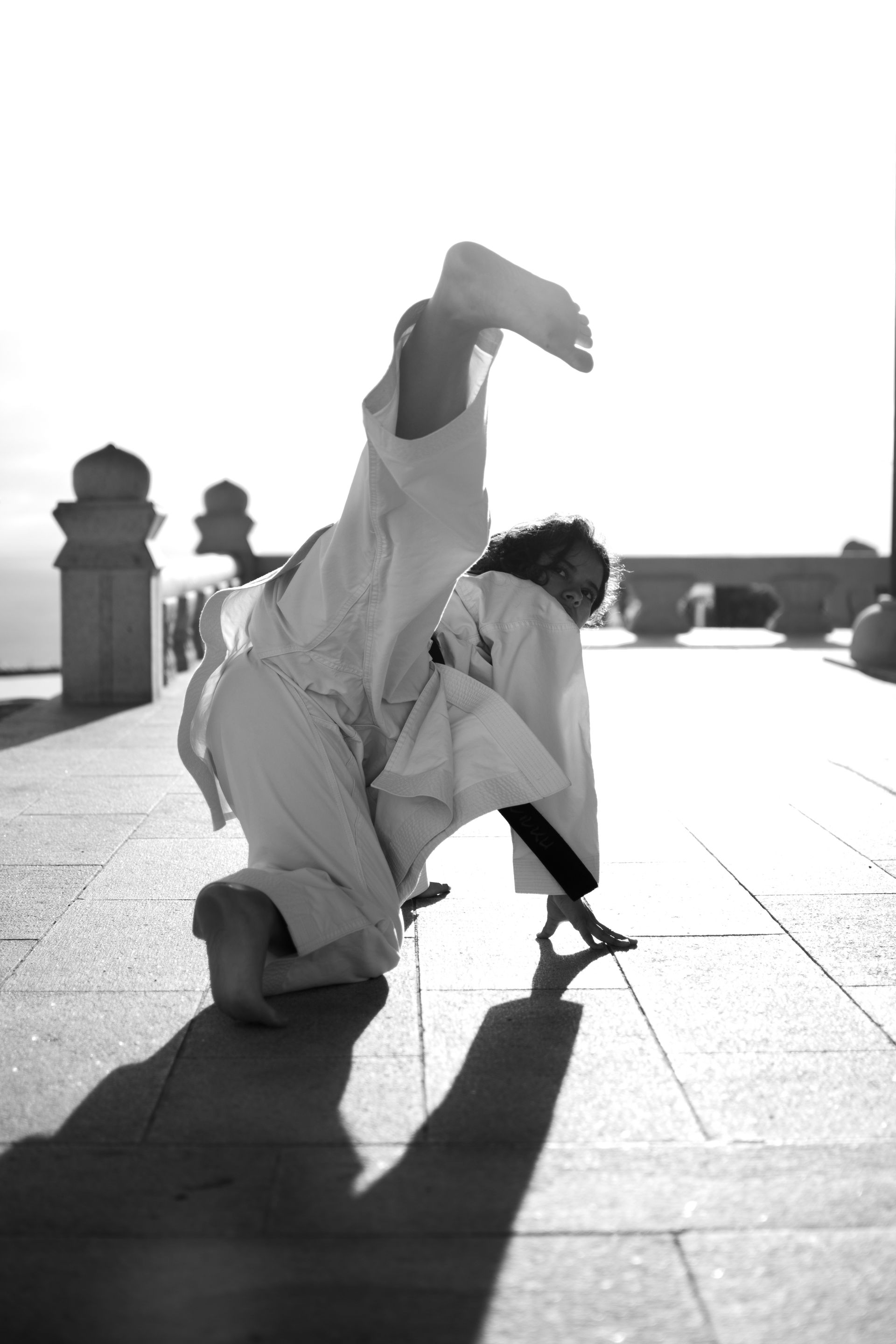 A black and white photo of a person doing a flip at the Korean Friendship Bell