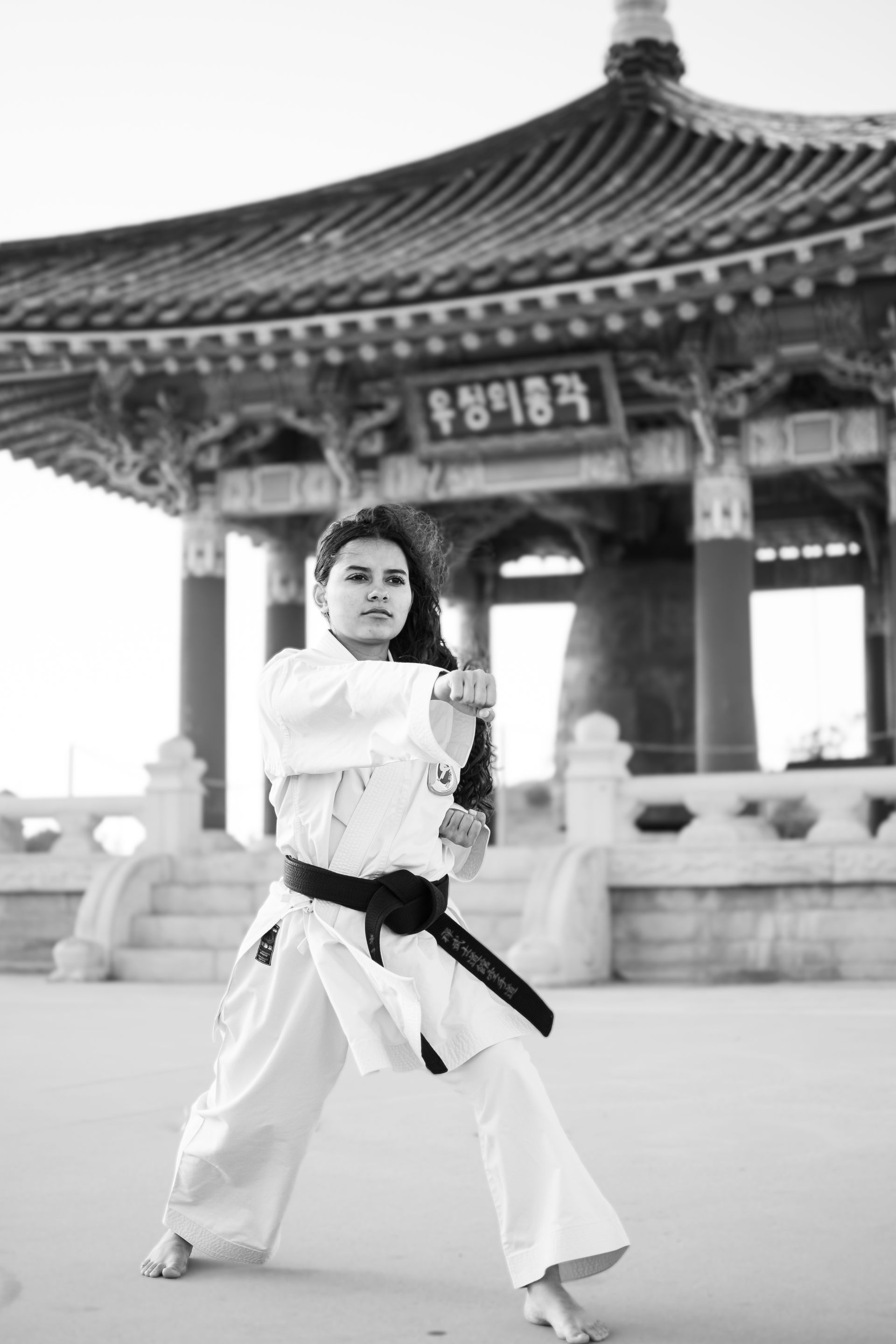A black and white photo of a woman practicing karate at Angel's Gate