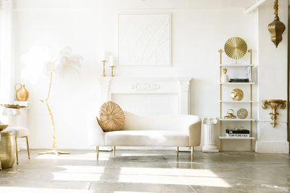 A living room with a white couch and a fireplace.