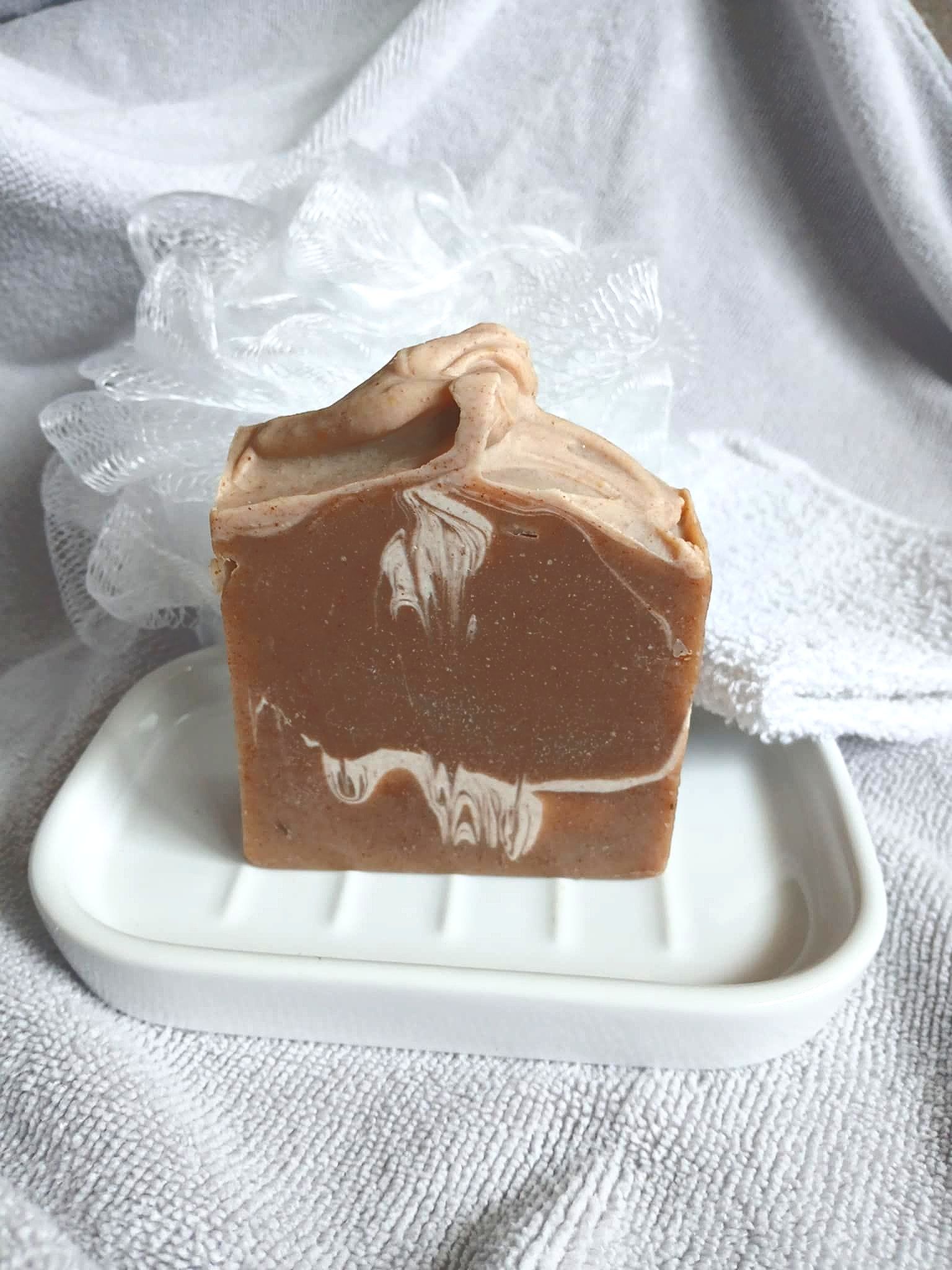 A person is holding a piece of soap in their hand.