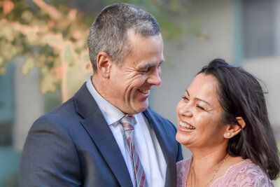 A man and a woman are looking at each other and smiling.