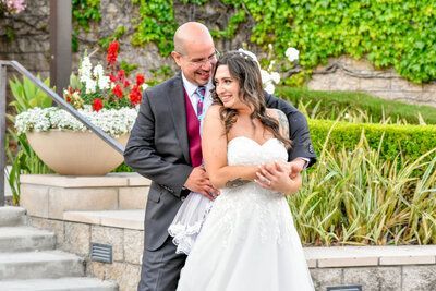 A bride and groom are posing for a picture on their wedding day.