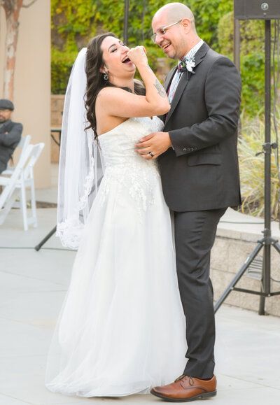 A bride and groom are dancing together at their wedding reception.