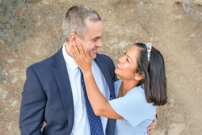 A woman is putting her hand on a man 's face.