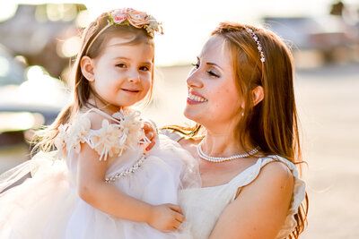 A woman is holding a little girl in her arms. Family. 
