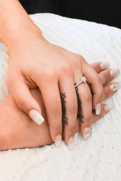 A close up of a woman 's hand with a ring on it Wedding ring
