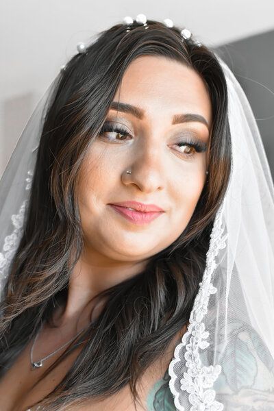 A close up of a woman wearing a veil and a tiara. Bridal portrait. 