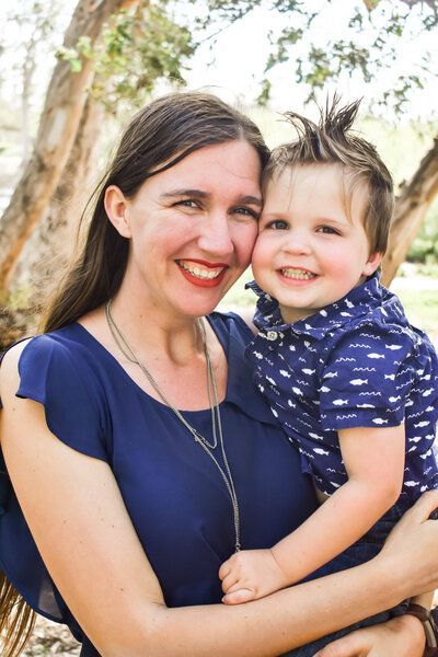 A woman is holding a little boy in her arms. Family. 