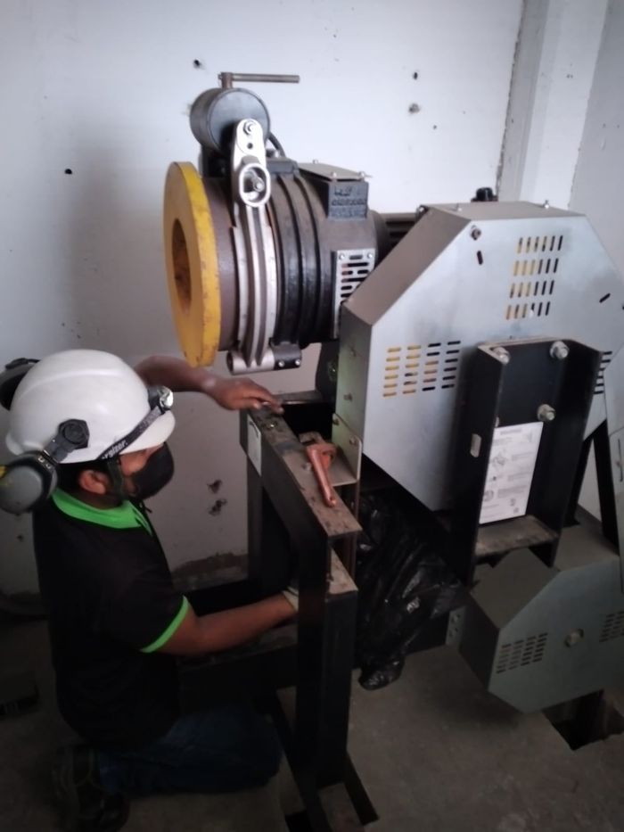 Un hombre que lleva un casco está trabajando en una máquina