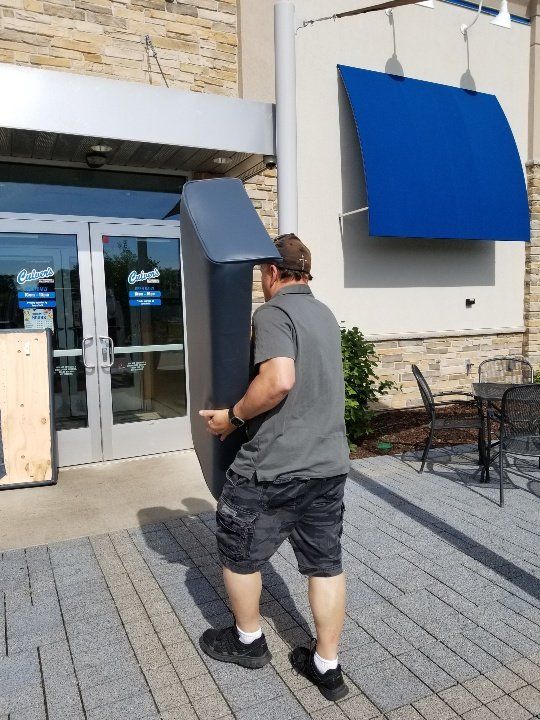 Man Holding a Couch Cushion — Watertown, WI — Recovery Room Commercial Upholstery
