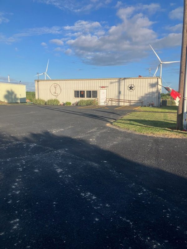 A building with a star on the side of it and windmills in the background.