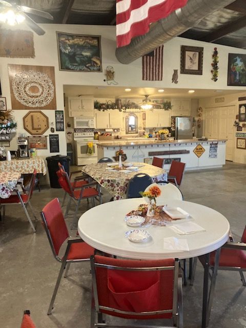 A room with tables and chairs and a flag on the wall
