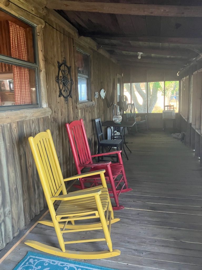 Two rocking chairs are sitting on a porch next to each other.