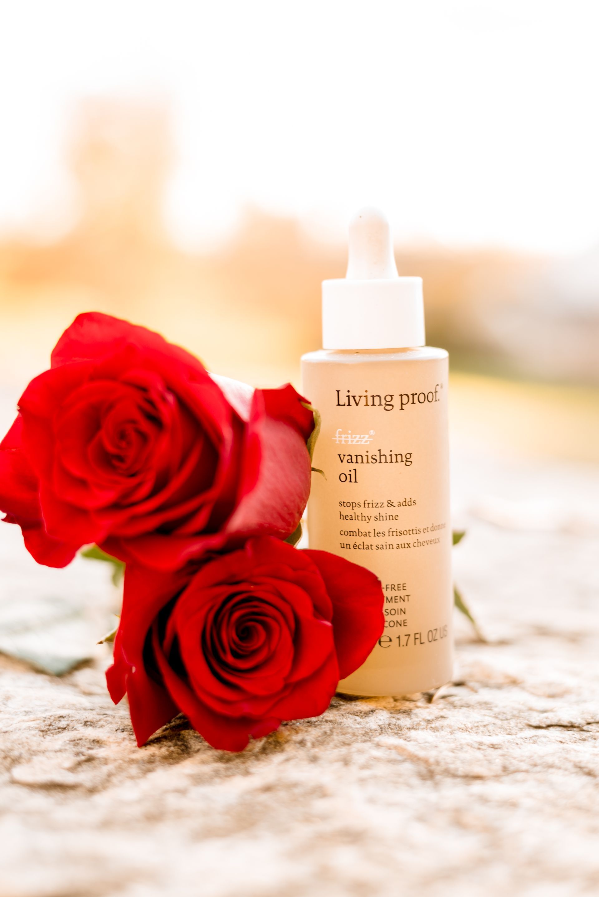 Red roses next to a bottle of 