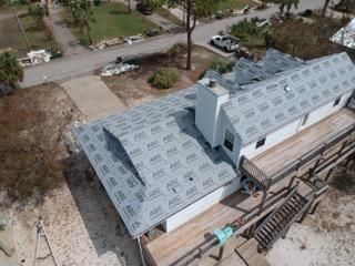 An aerial view of a house with a roof that is being installed.