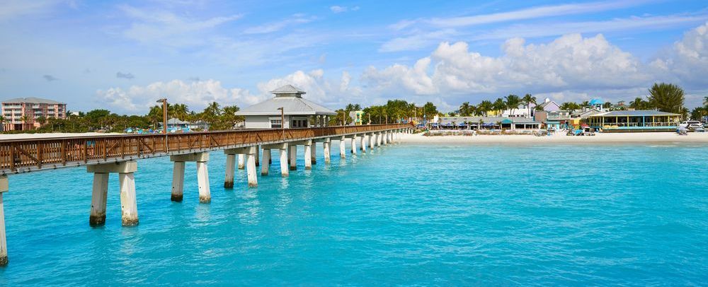 There is a pier in the middle of the ocean.
