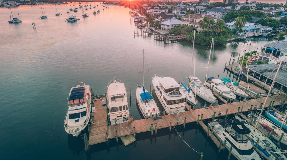 An aerial view of a marina with boats docked at sunset.