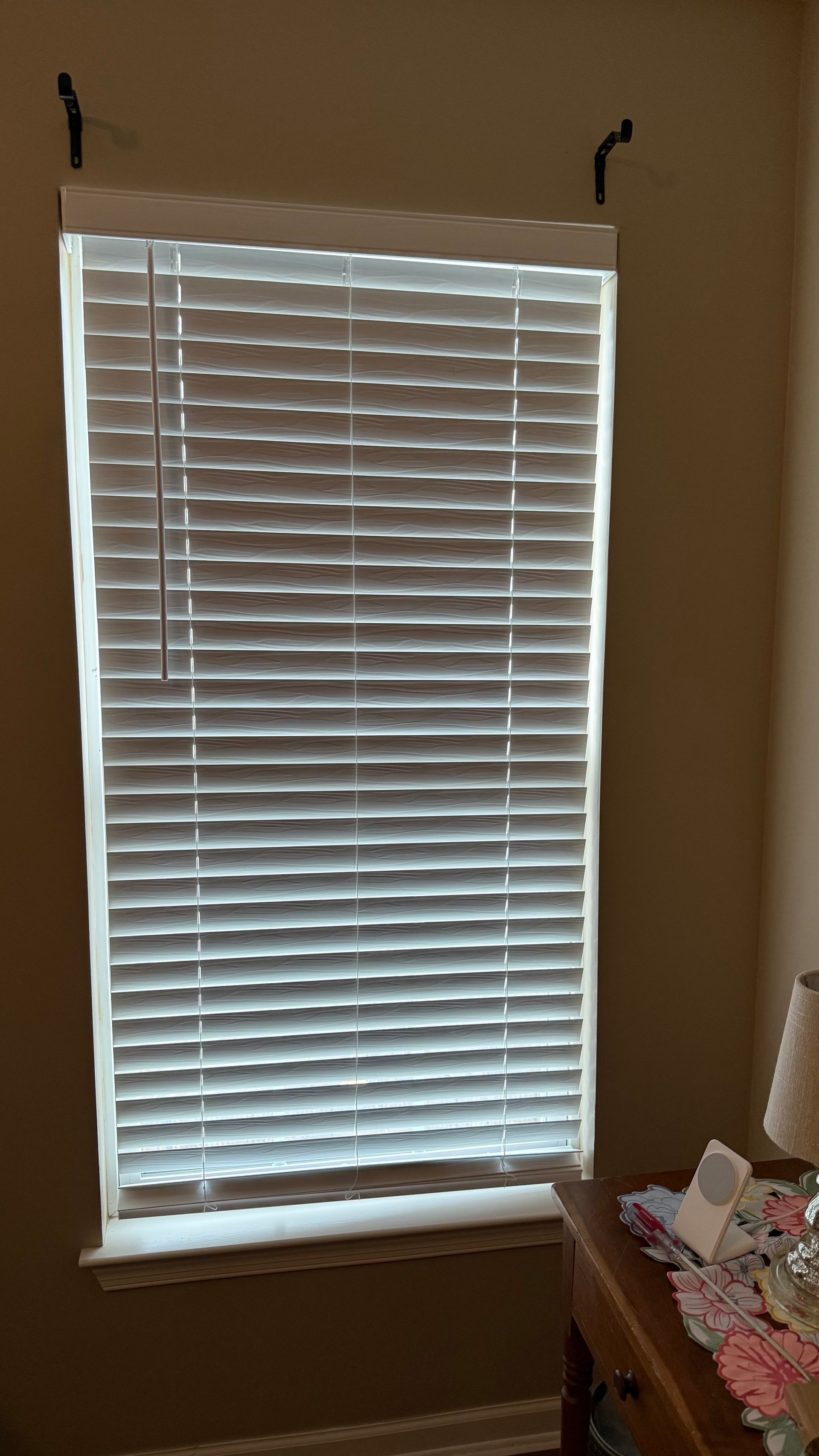 There is a window with blinds on it in a room.