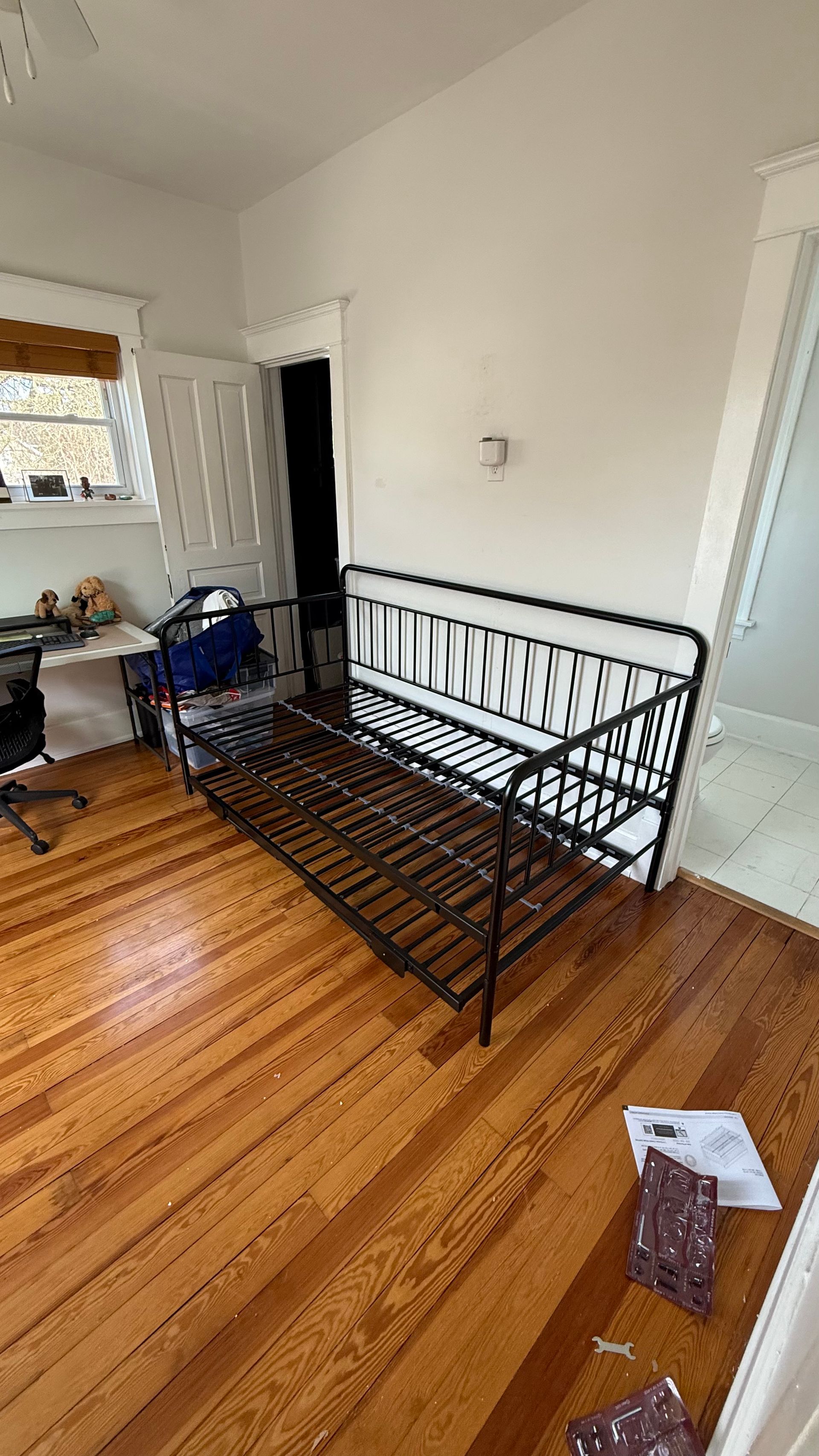 There is a day bed in the middle of the room.