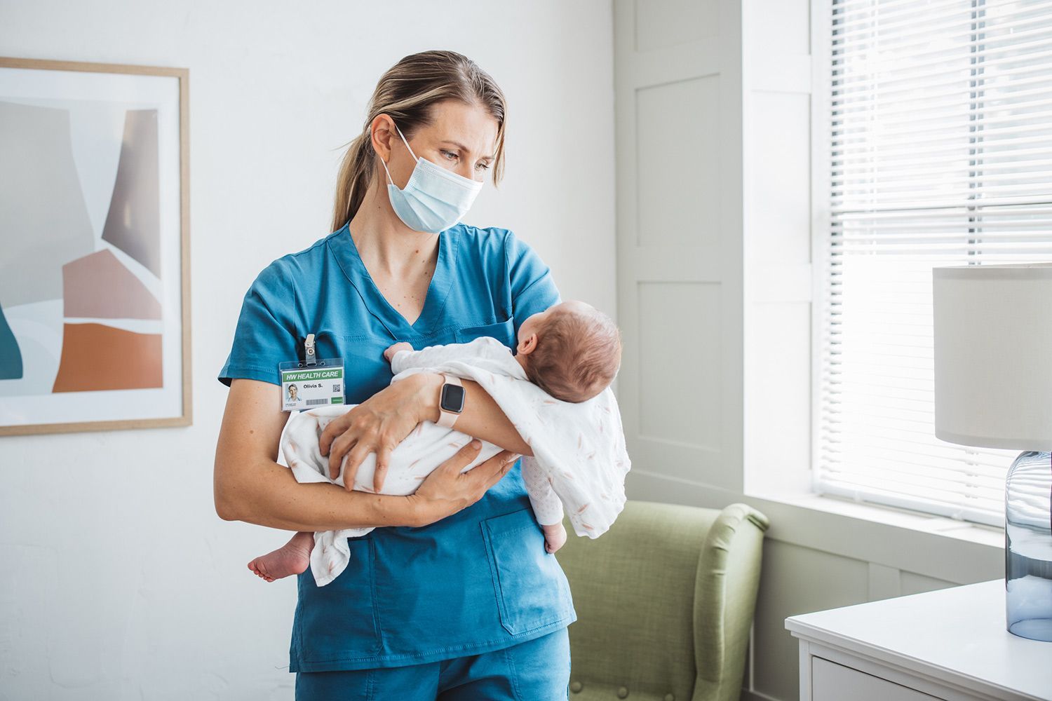 Nurse Holding a New Born Child — Houston, TX — Rosewood Career Institute Inc.