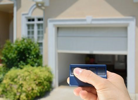 Garage door opener opening a residential garage door.