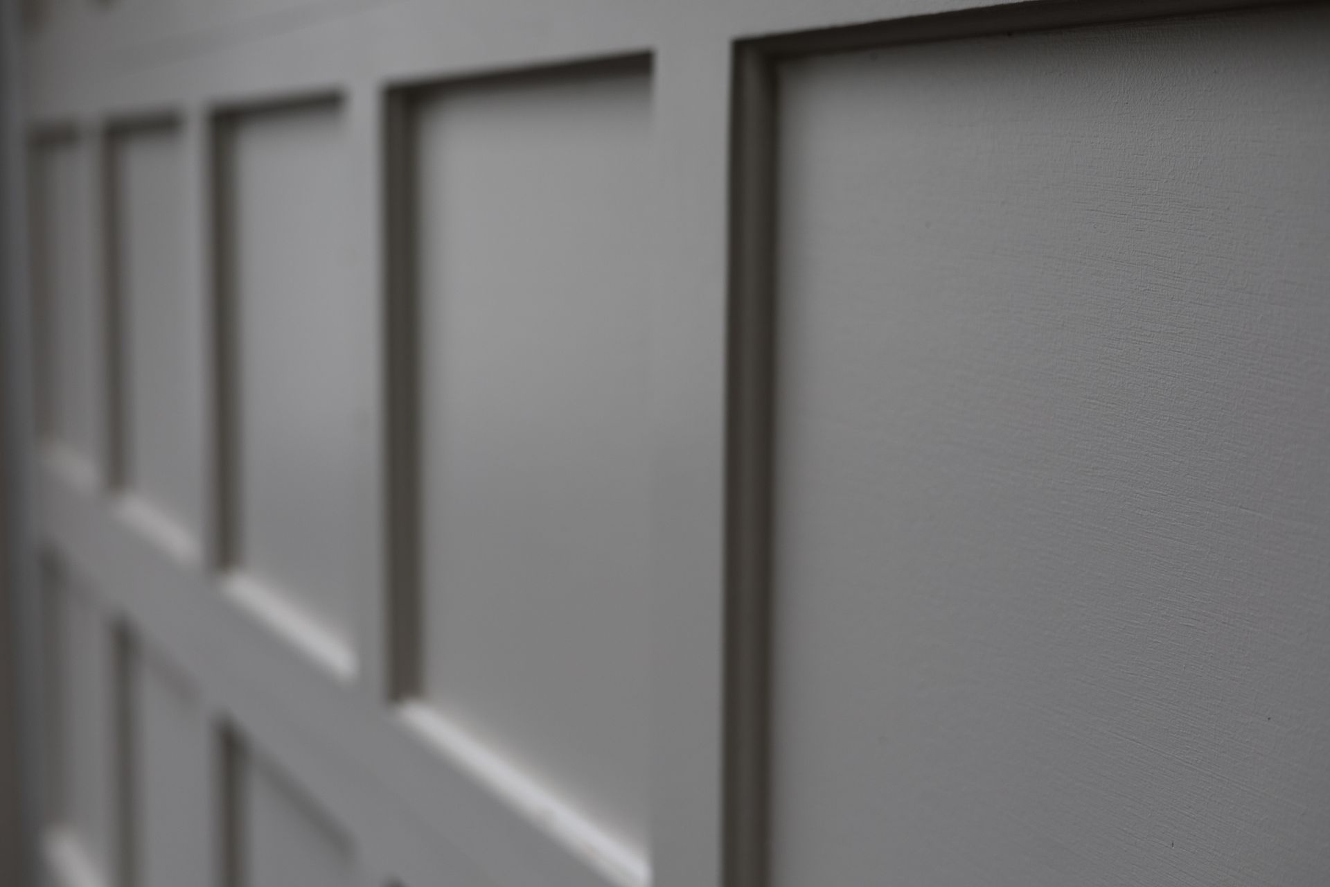 Closeup of a Gray garage door that looks brand new. Closeup of a Gray garage door that looks brand new.