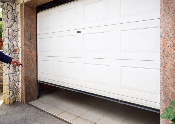 Hand Opening a New Garage Door — Milwaukee, WI — Advance Overhead Door, Inc
