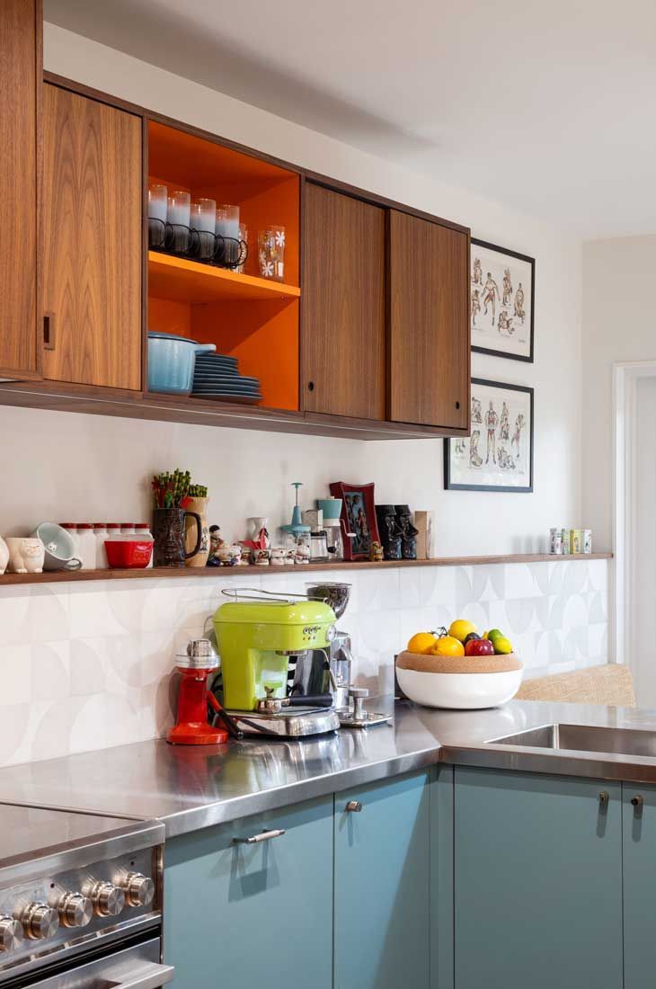 A group of people are sitting on a patio in front of a house.