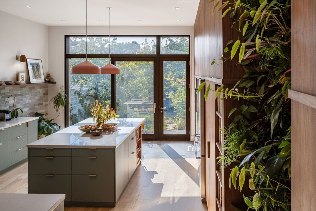 A kitchen addition with a large island and lots of windows.