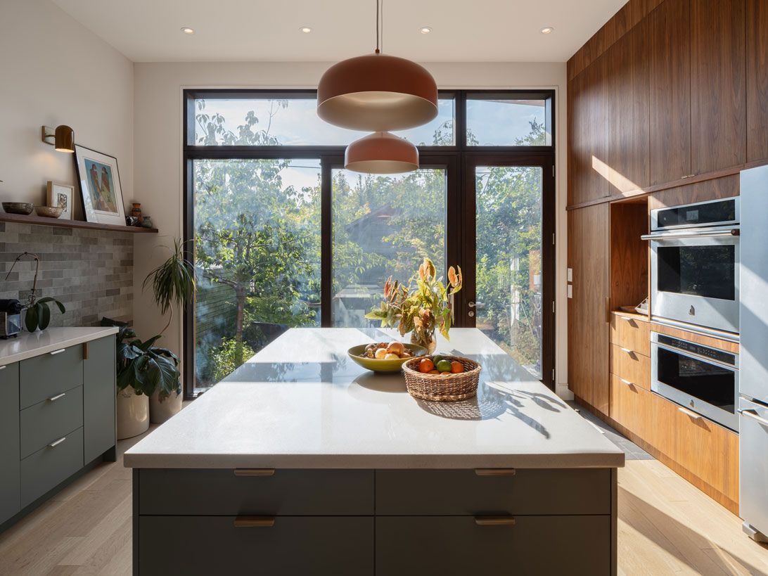 A kitchen addition with a large island and a large window.