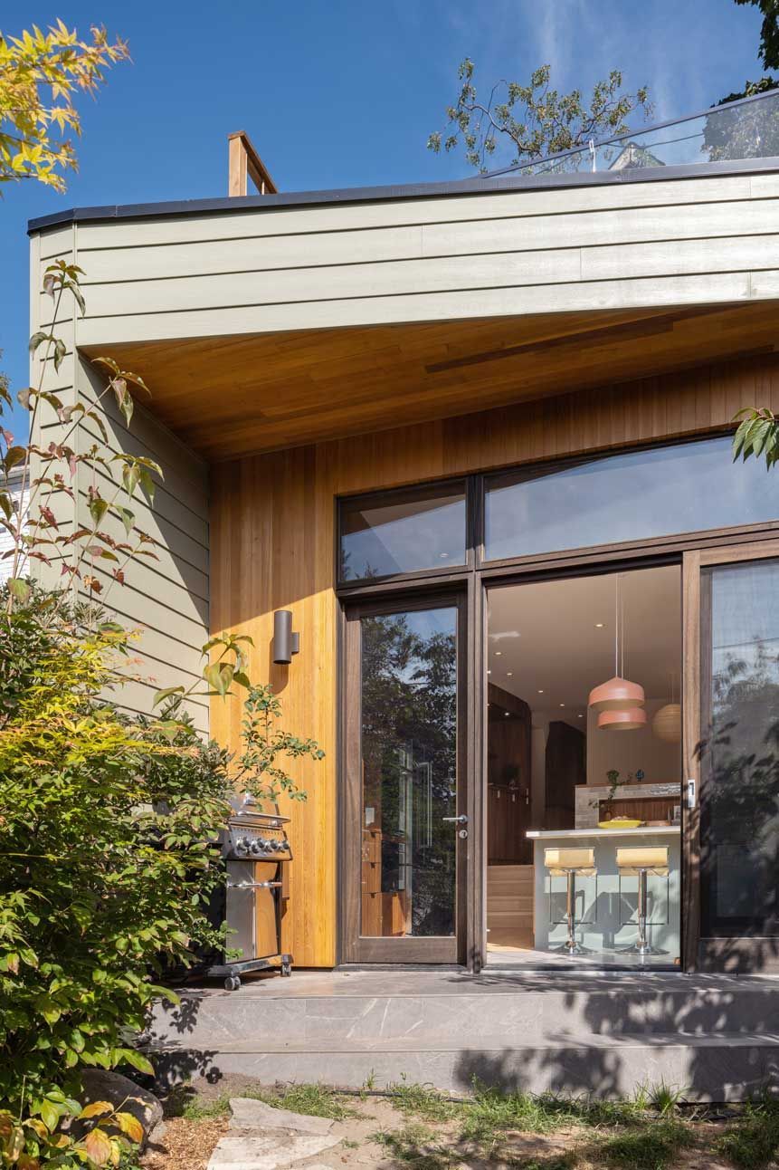A house with a lot of windows and a sliding glass door.