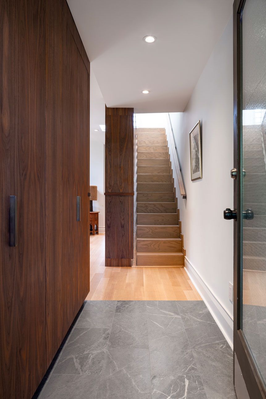 A hallway with stairs leading up to the second floor addition of a house in Upper Beaches, Toronto.