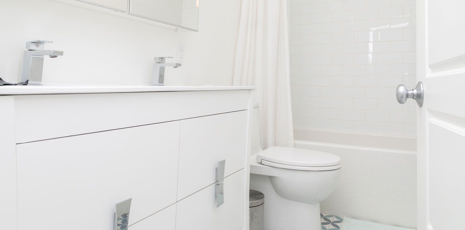 A bathroom with a toilet , sink , and shower.
