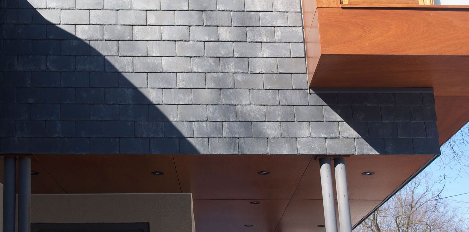 A building with a roof made of slate and wood