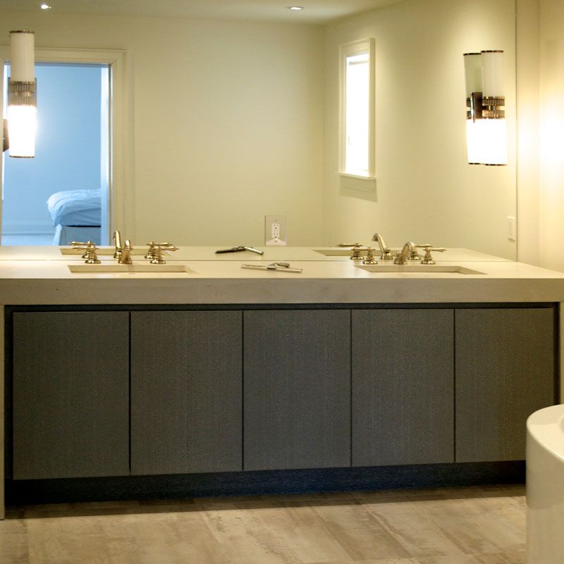 A bathroom with two sinks and a mirror